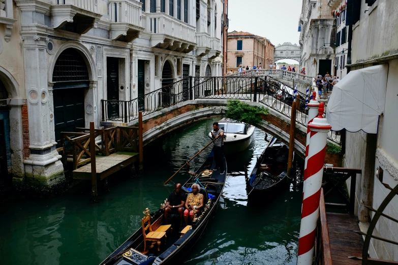 a boat with people riding on it traveling down the water