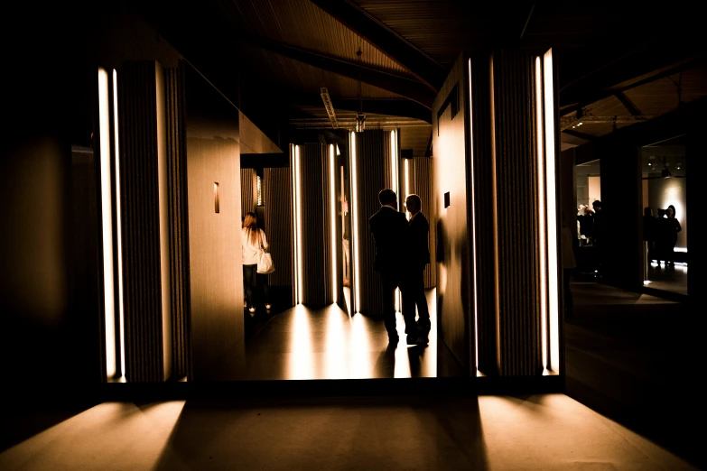 a hallway lit by bright lights leading from the side
