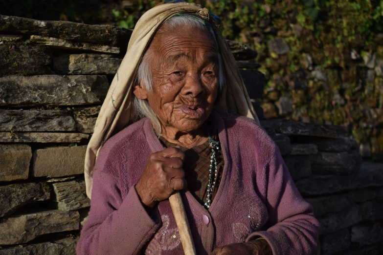 an old woman with a cane and a basket