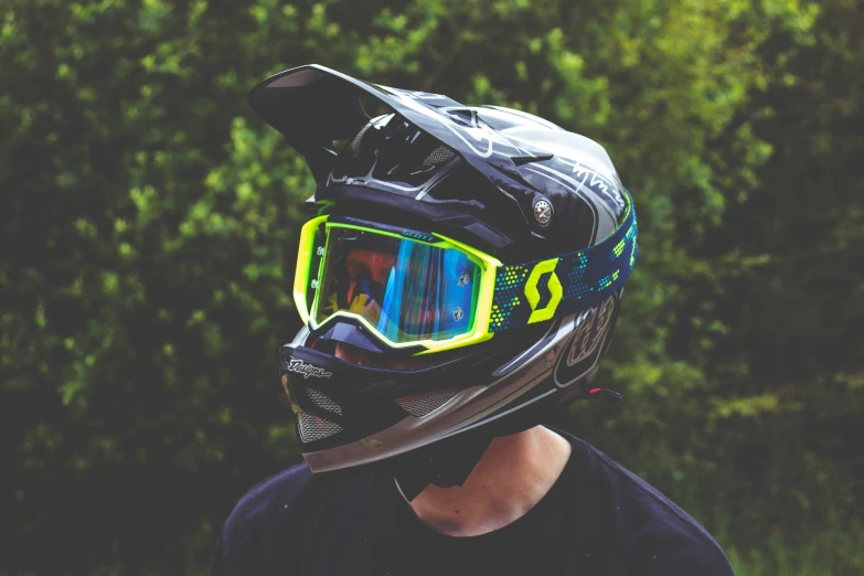 the young man is wearing a protective helmet and goggles