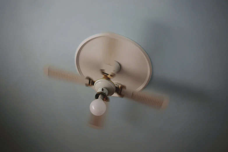 the ceiling fan with a bulb is being viewed from below