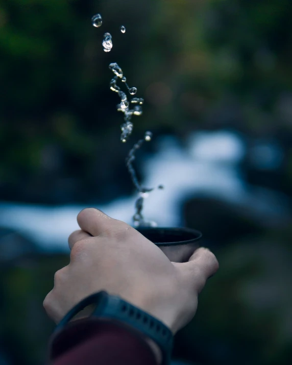 a person sprinkles water into their hand