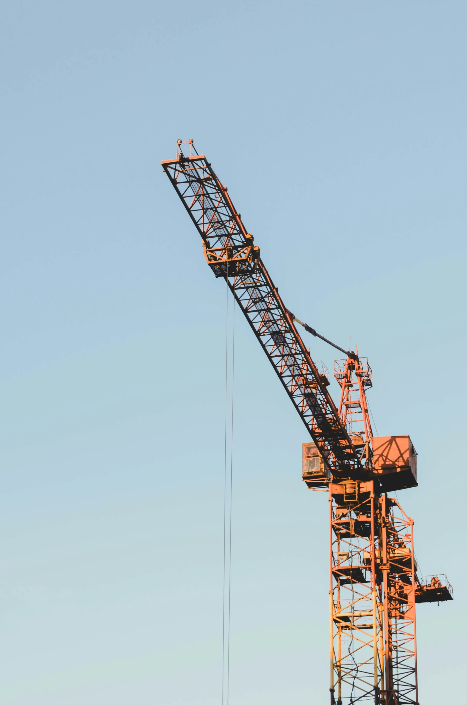 a crane against a blue sky on a sunny day