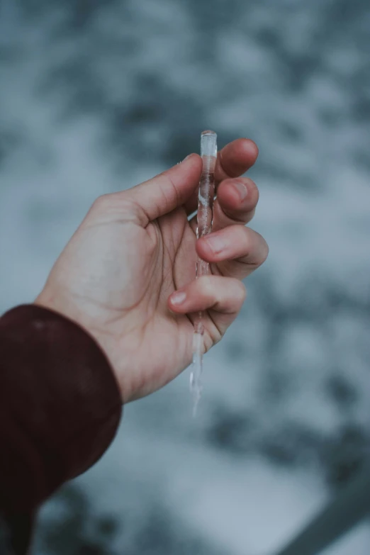 a person holds soing clear with their hand