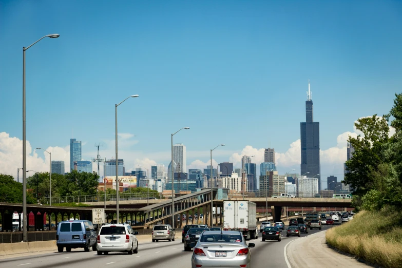 a highway with lots of traffic and tall buildings