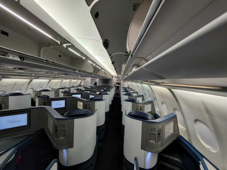 the inside of an airplane showing its empty booths