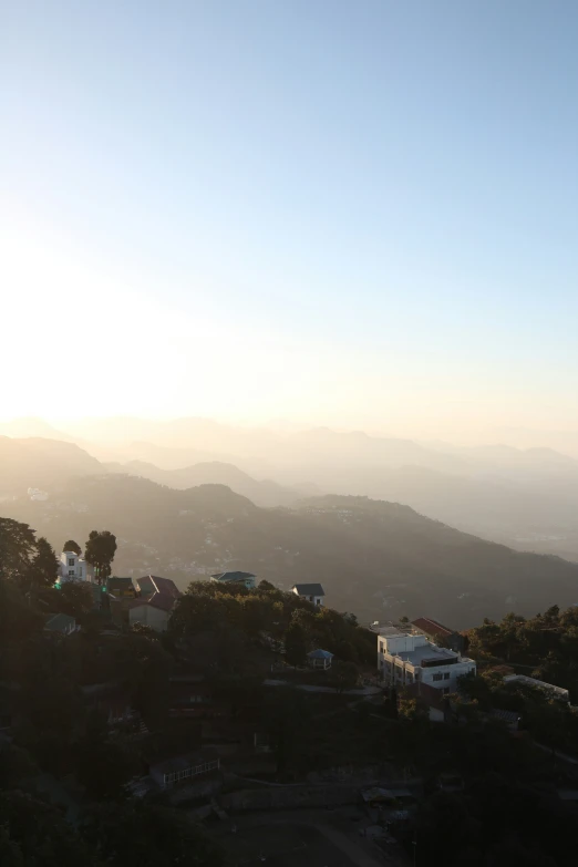 a hazy view of the mountains and the buildings on the hillside