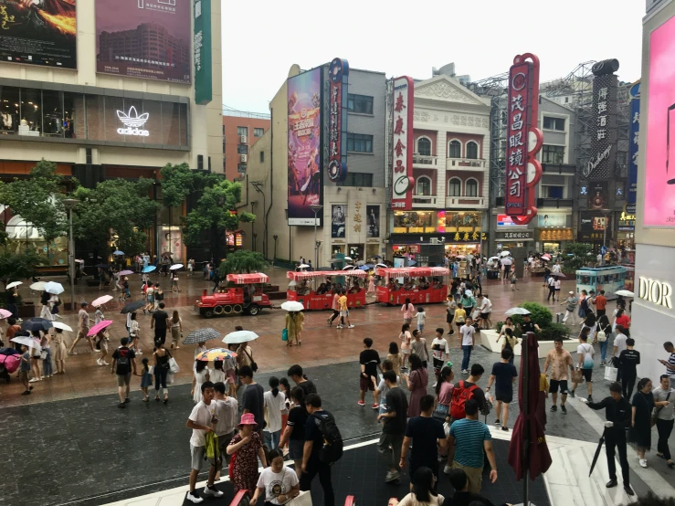 crowds are gathered together in an outdoor plaza