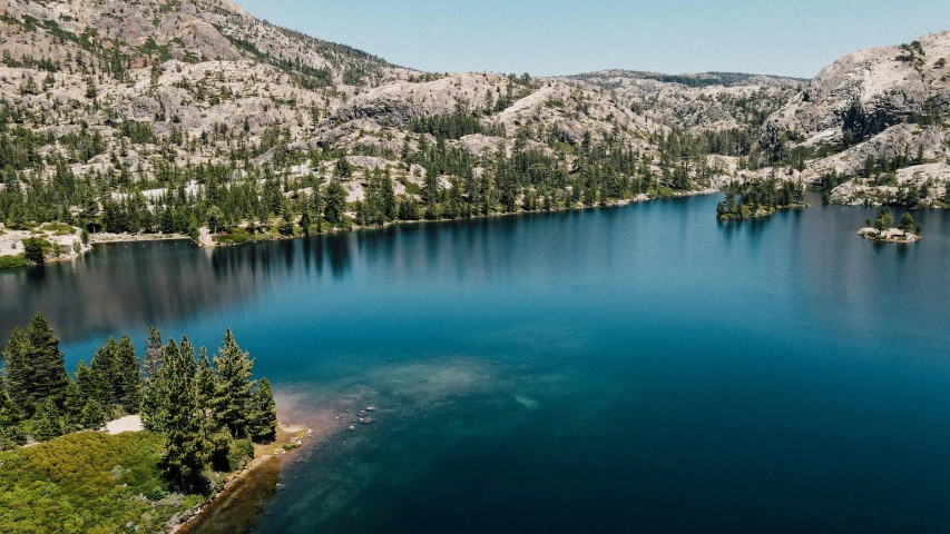 a lake surrounded by mountains with trees on each side