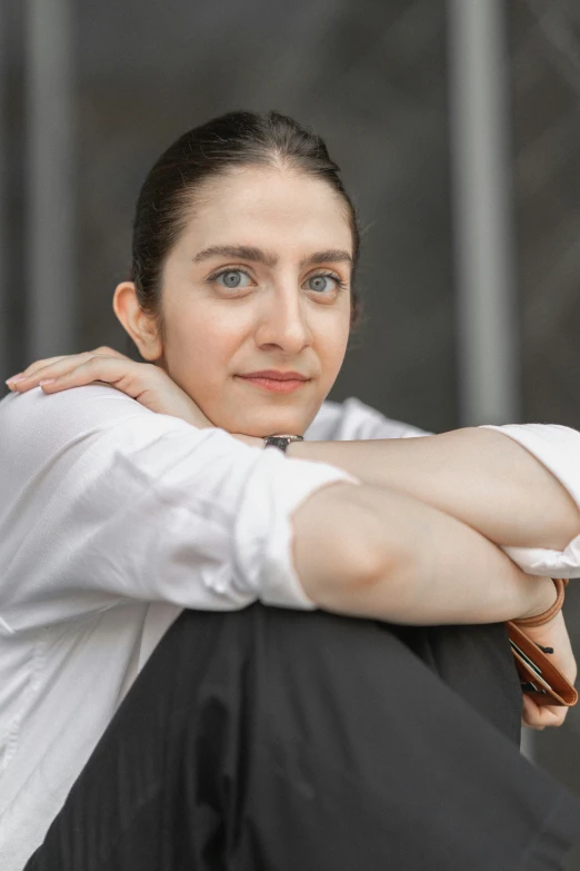 a person sitting down with their arms crossed