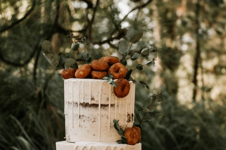 a wedding cake is decorated with oranges and greenery