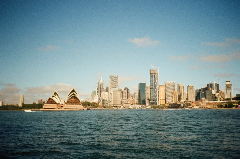 the skyline of a large city sitting in a bay next to the ocean