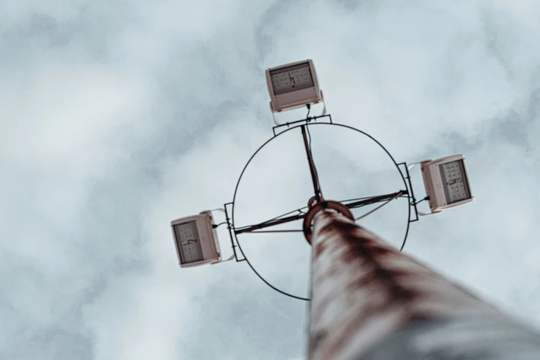 a view up into the sky of a pole with lights