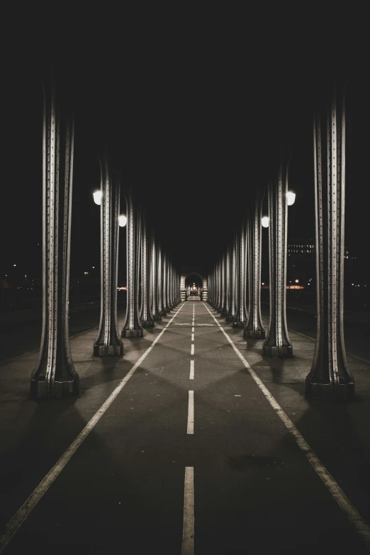 a large street is lined with lamps in the night