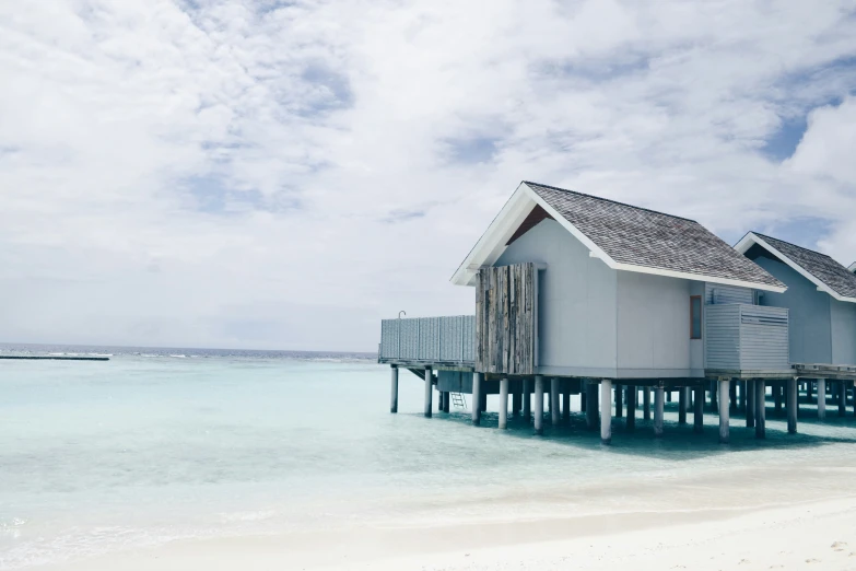 a house that is on a pier in the ocean