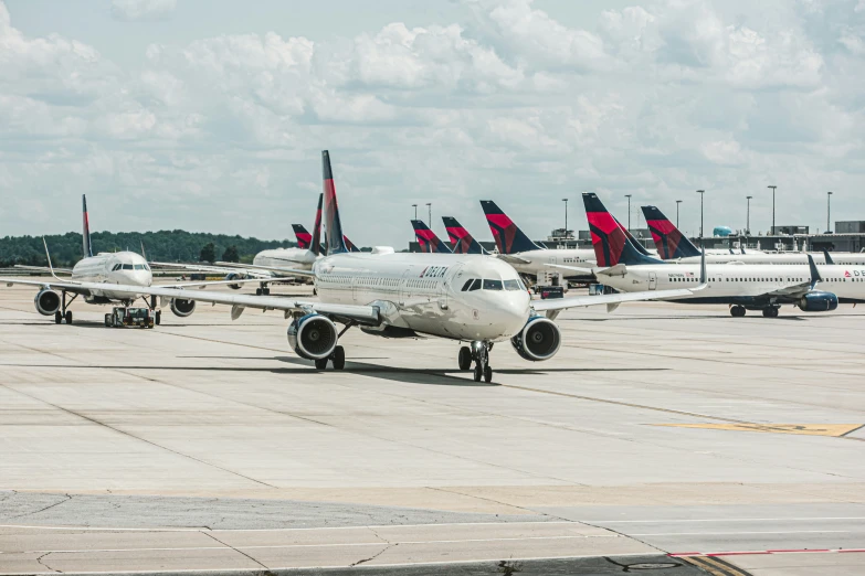 an airport with several jet airplanes parked on the runway