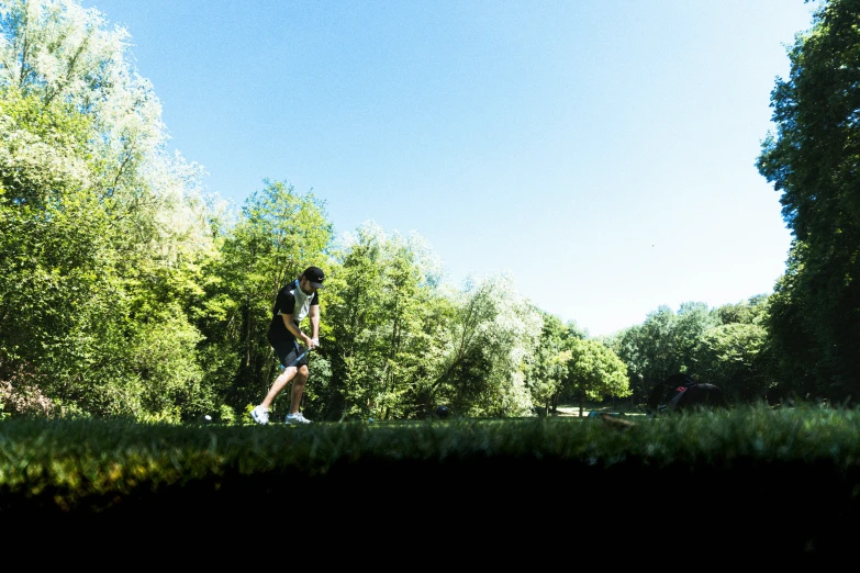 a person standing in the grass with a frisbee