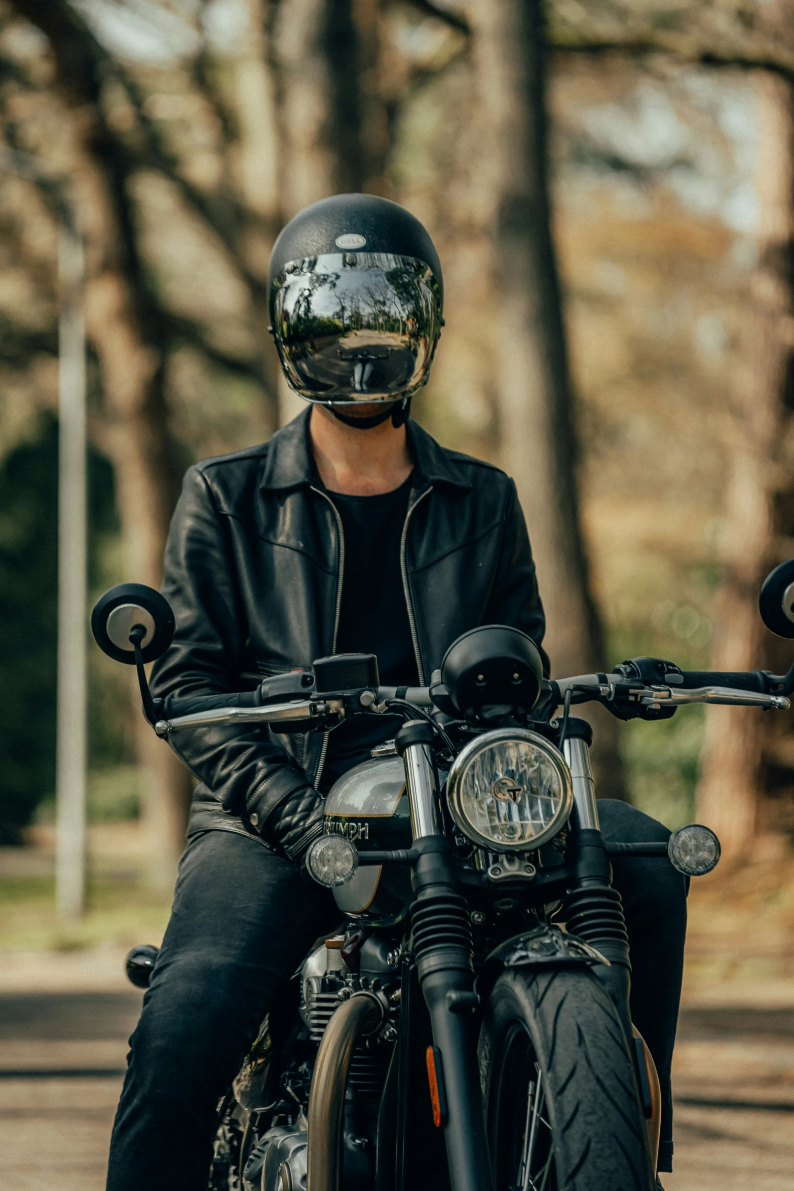 the man is wearing black leather gloves while riding his motorcycle