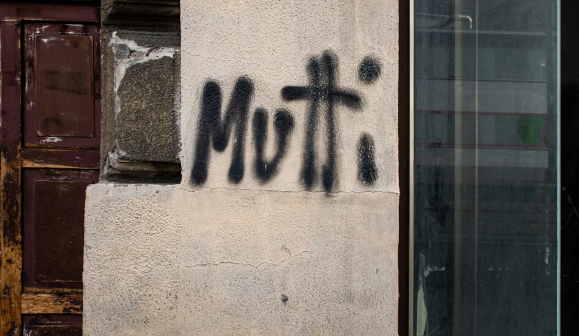 the word mother painted on a wall with two crosses