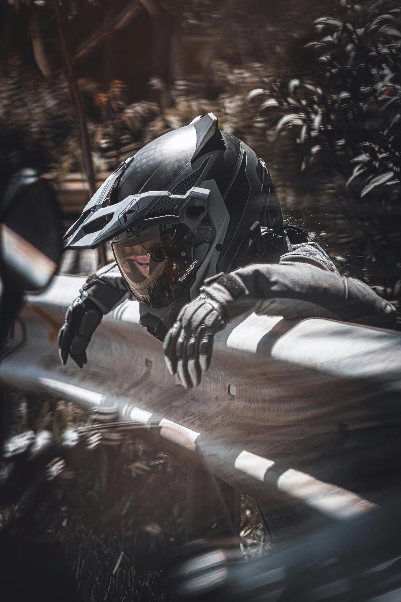 a man falling off his motorcycle is riding through the water