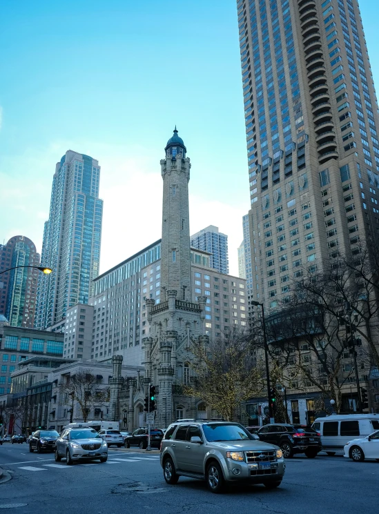 a very tall building and cars on a busy street