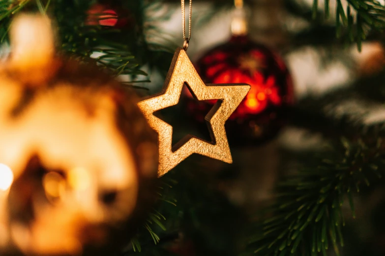 a christmas tree with two star ornaments