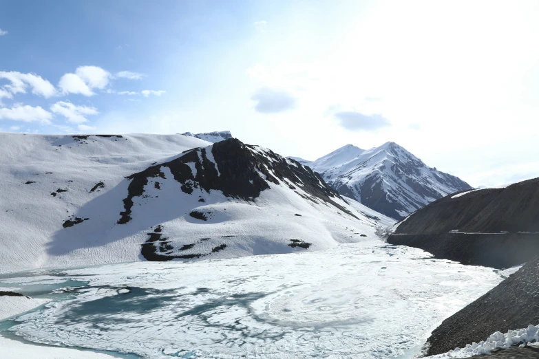 a man standing on a mountain with a backpack and ski poles