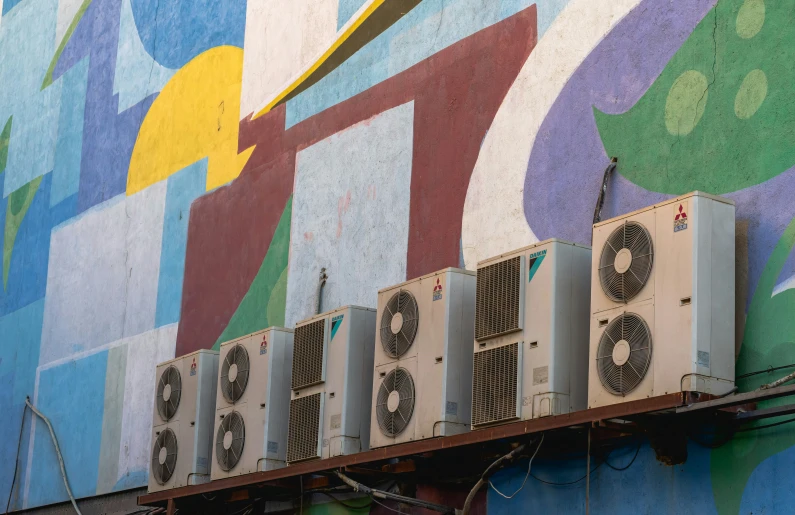 some air conditioners on the outside of a building