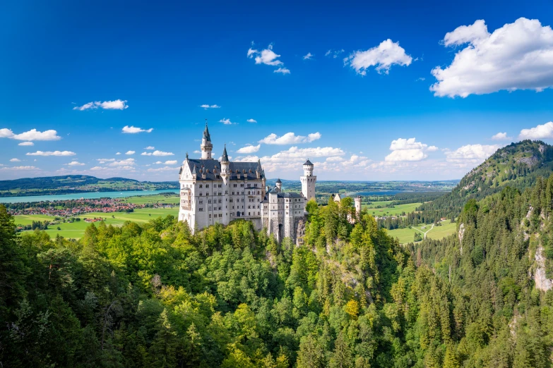 a large castle perched on top of a green hillside