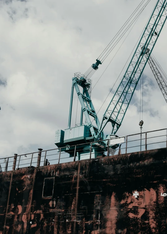 there is a large crane that is standing on a construction site