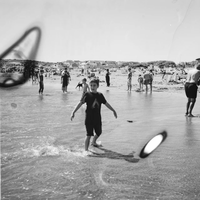 a boy plays with a paddle in the ocean