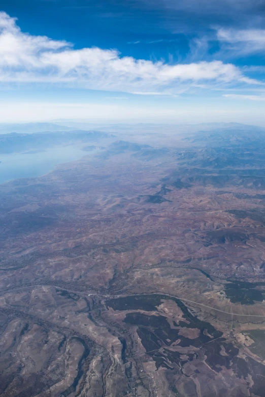 a view from the top of a mountain shows a valley and river below