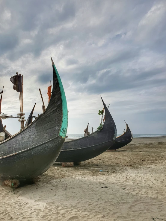 there are two boats parked at the beach