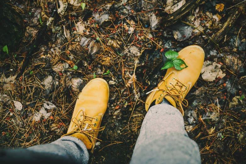 a person in yellow boots standing on the ground