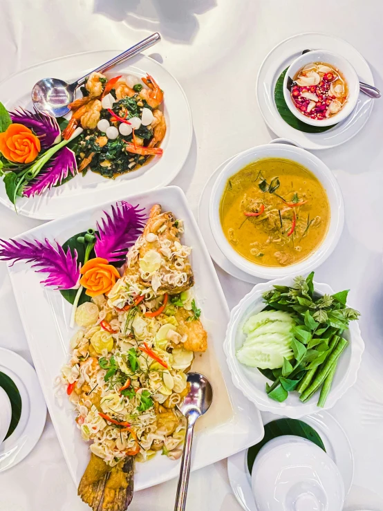 a table full of various dishes of food, some of them made from food