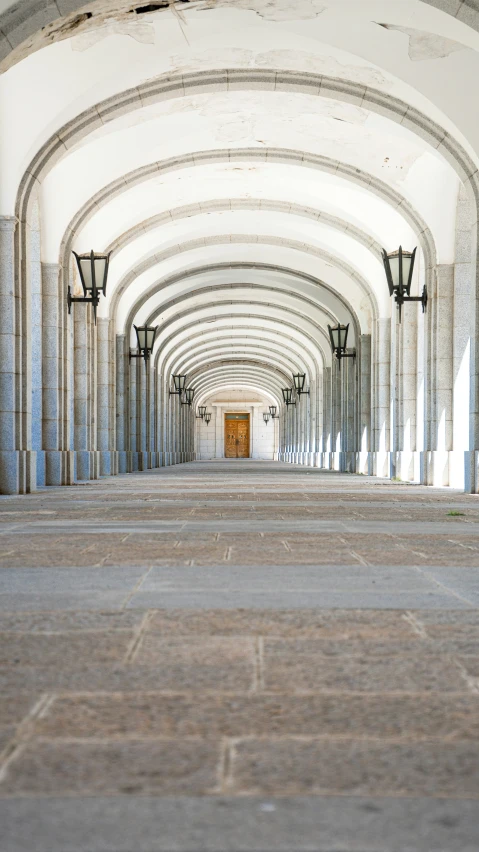 a empty building with lanterns and an archway