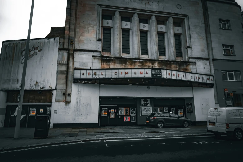 an old building with cars parked on the side