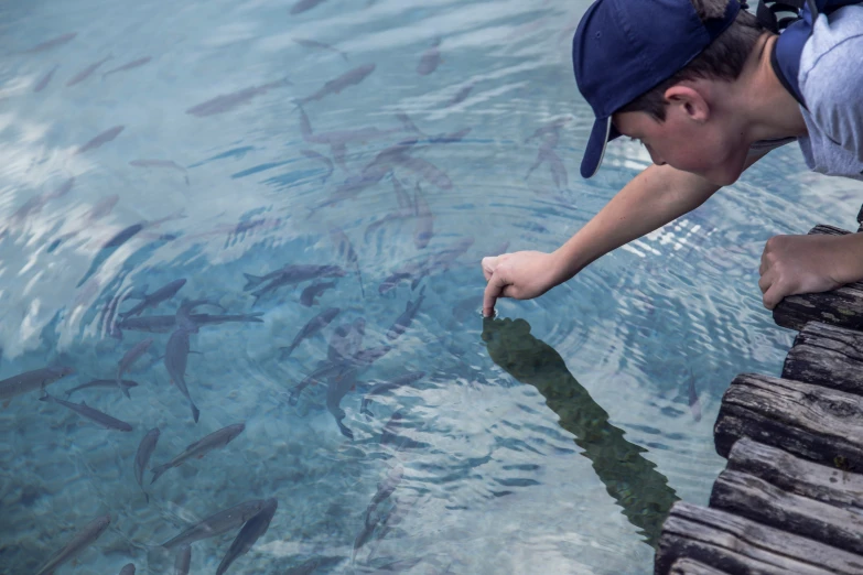 a man looking into the water for fish