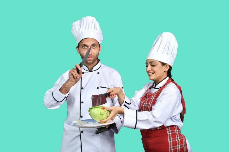 an adult male and female chef preparing food on plate