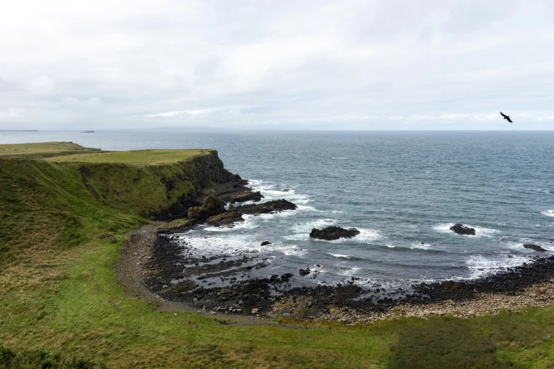 the ocean is shown from above with an island in the distance