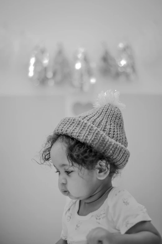 a  wearing a winter hat sitting in front of a mirror