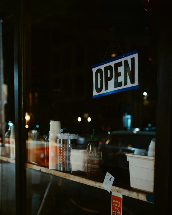 the window display of a restaurant showing bottles and containers of coffee