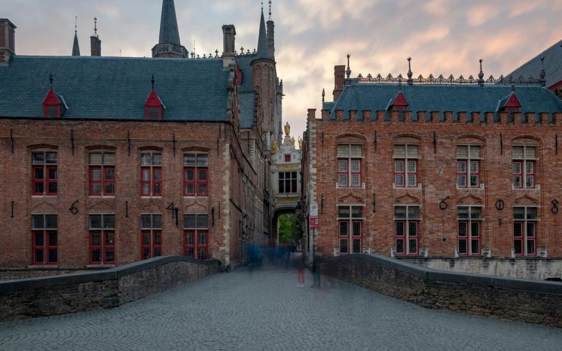 a group of people are walking in front of some buildings