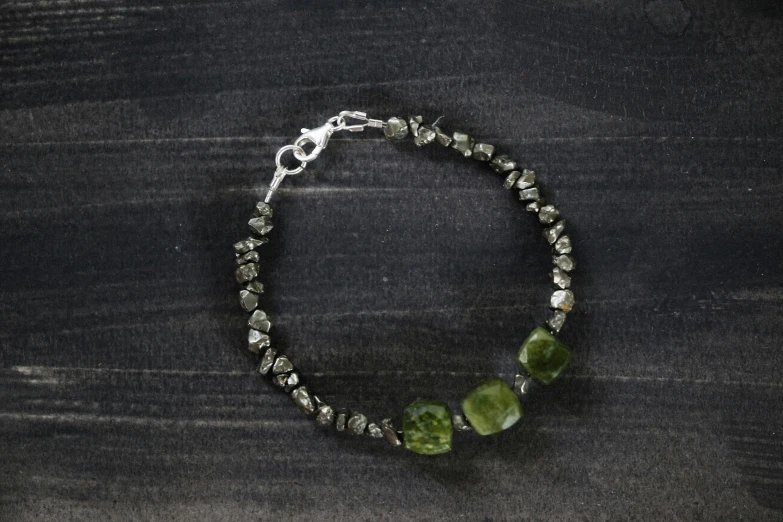 a celet with a silver plated charm and some glass beads