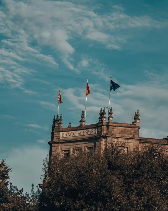 some three different flags on a castle building