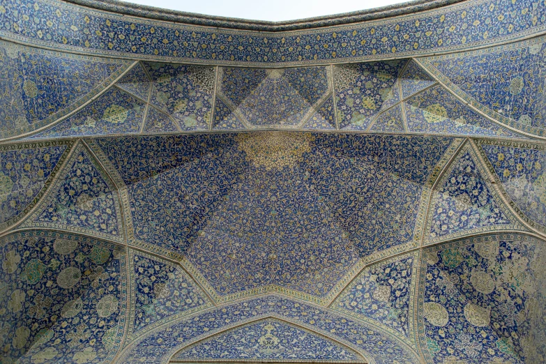 a blue and gold wall with intricate designs