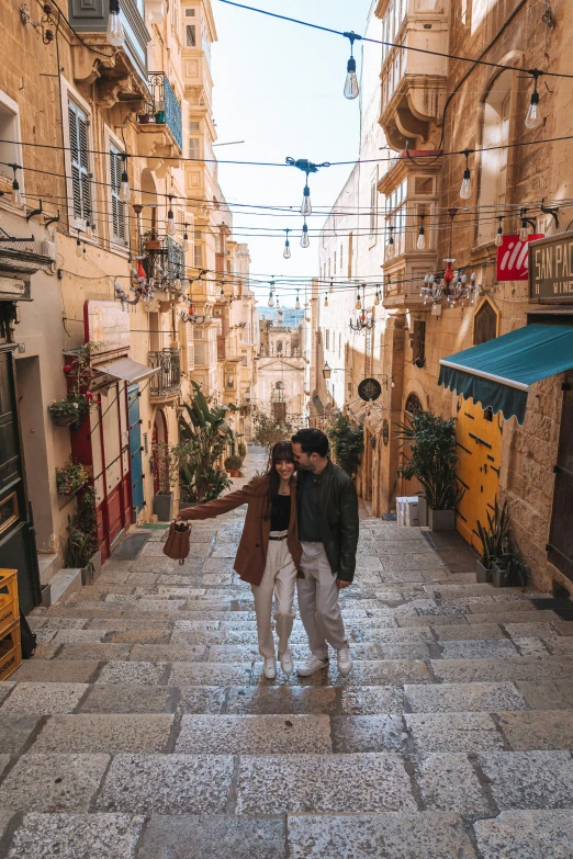 a man and woman kissing on the middle of an alley