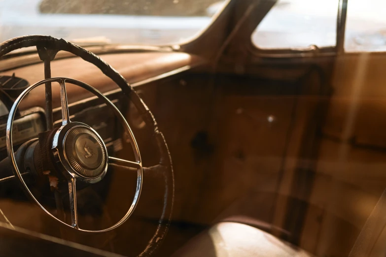 a po of a steering wheel inside an old car