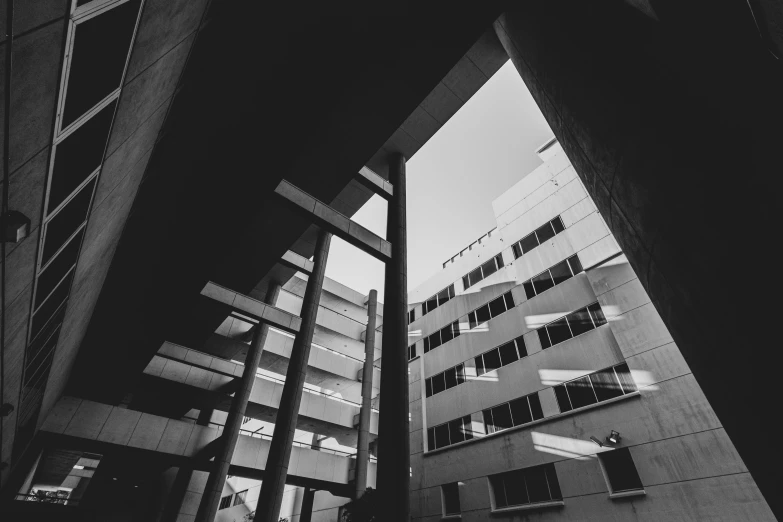 a black and white view of a building through an archway