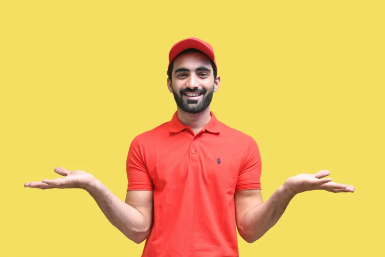 a man in a red shirt is balancing his hands with both hands